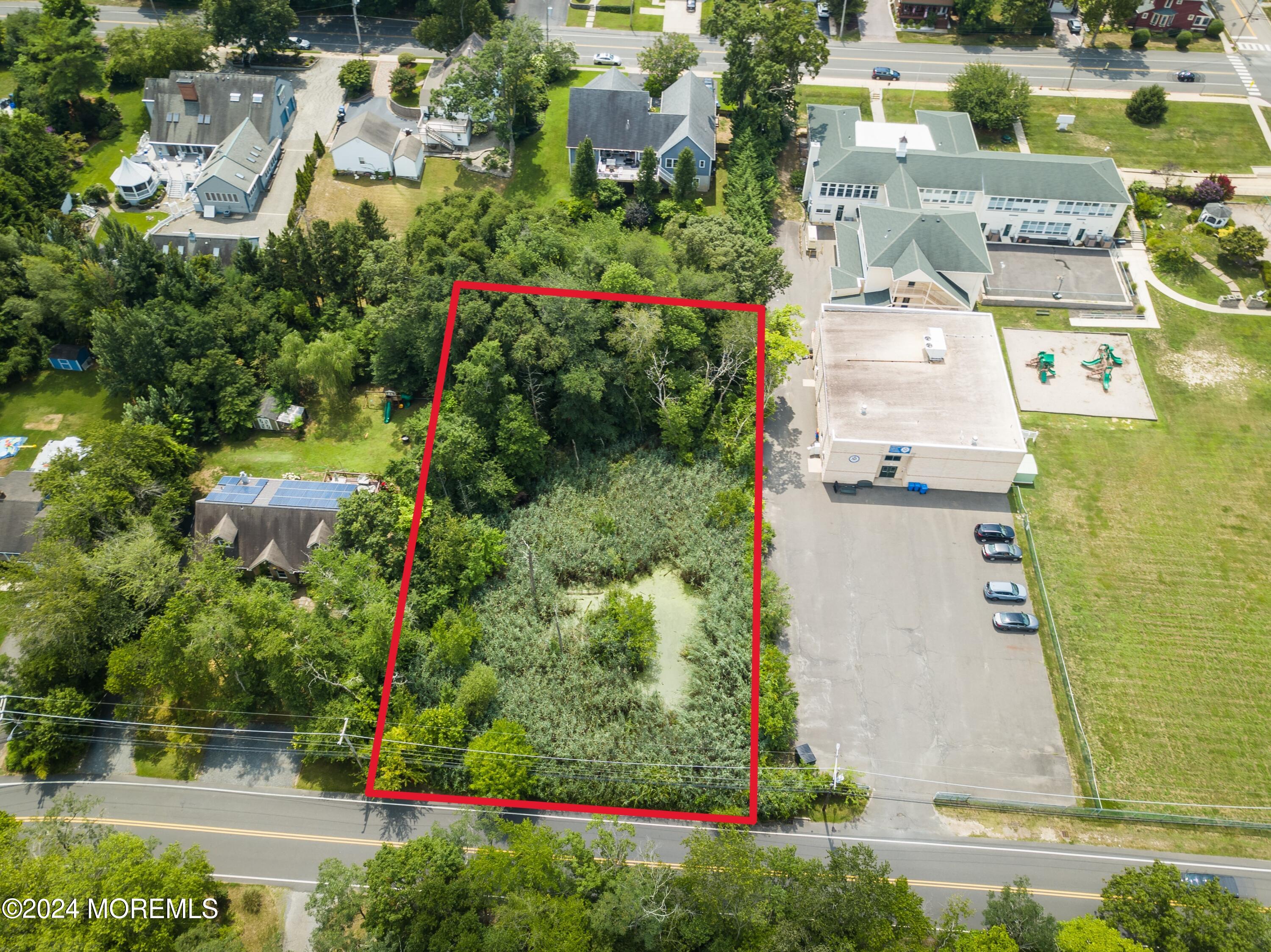 an aerial view of residential houses with outdoor space and street view