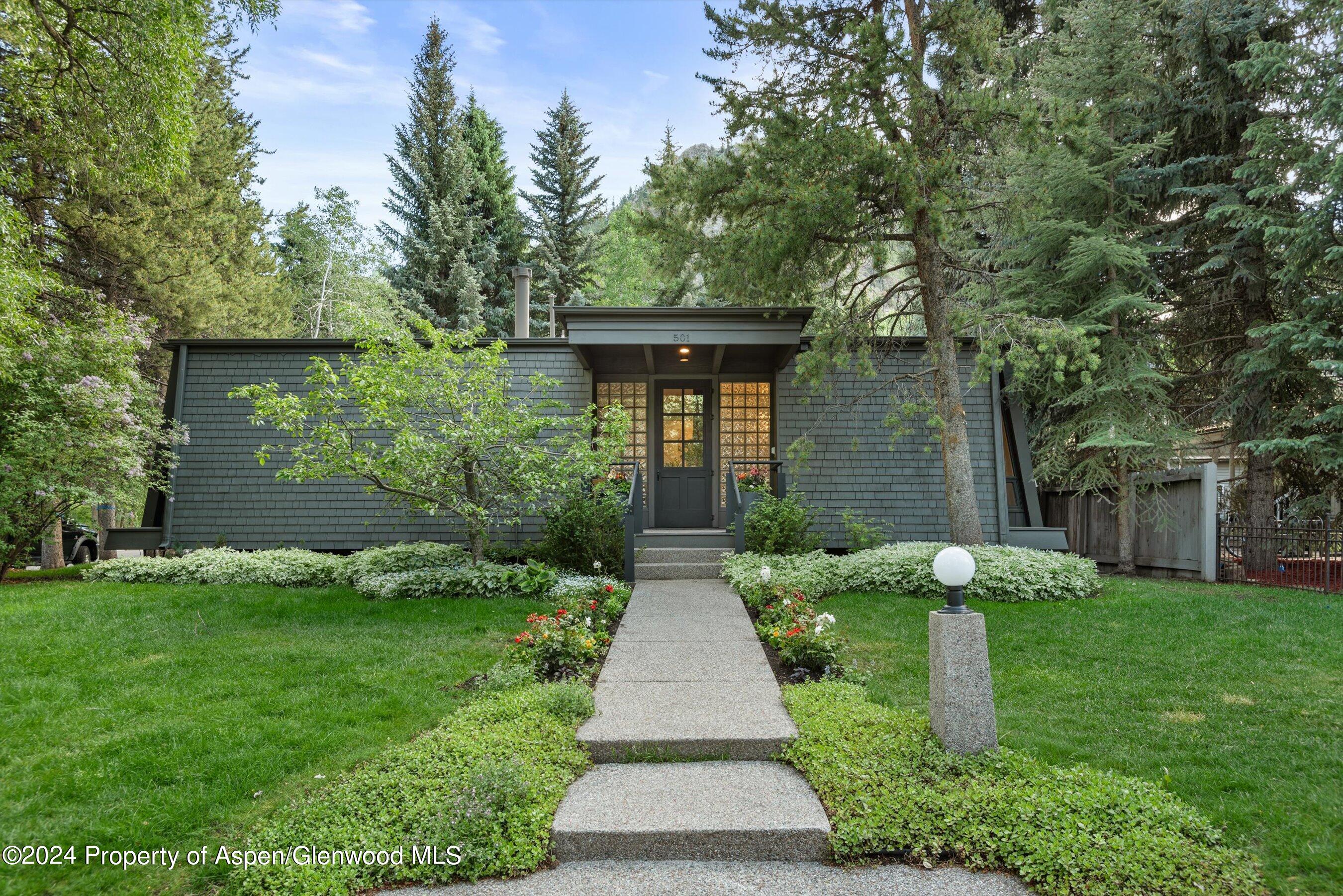 a front view of house with yard and green space