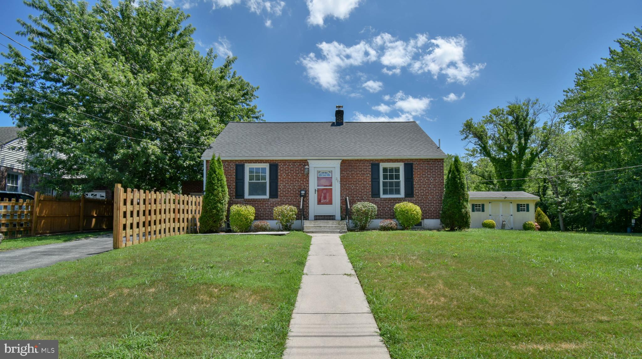 a front view of a house with garden and porch