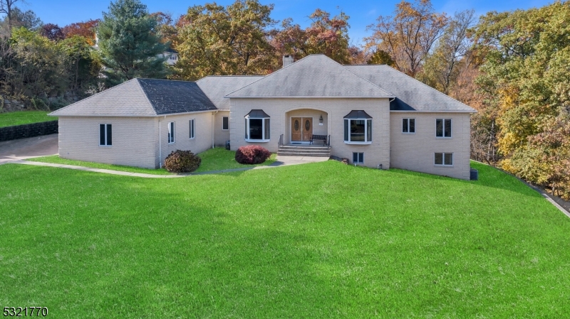 a front view of a house with yard and green space