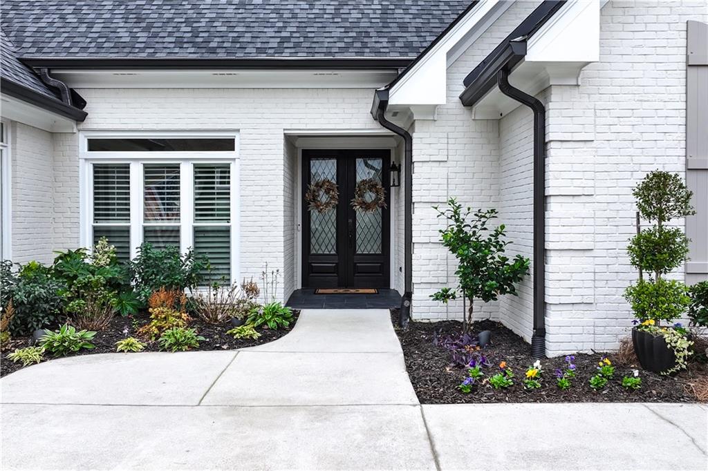 a view of a house with potted plants