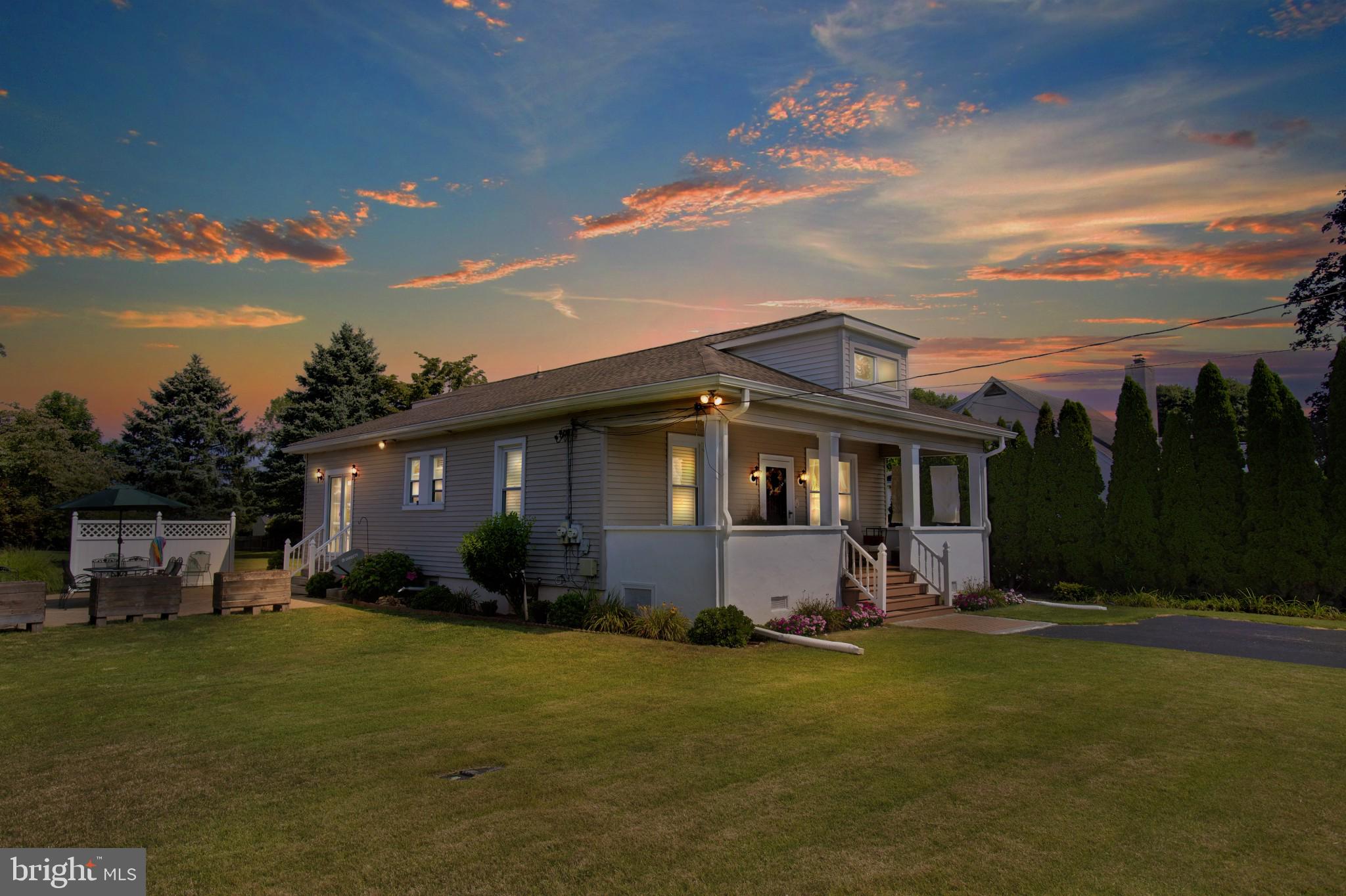 a front view of a house with a garden and yard