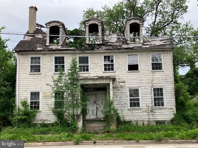 a view of a house with a balcony and windows