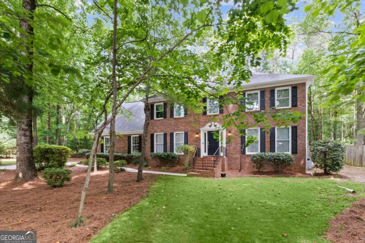 a front view of house with yard and outdoor seating