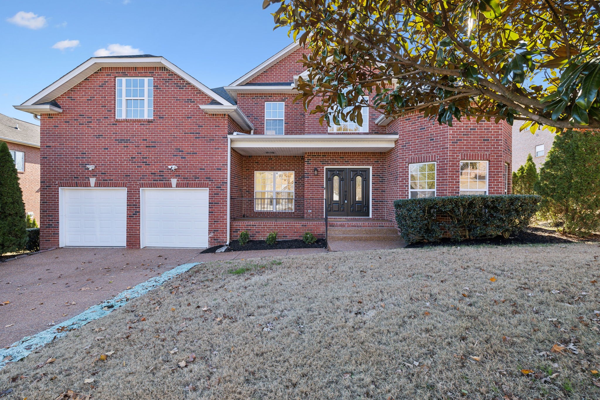 a front view of a house with a yard and garage