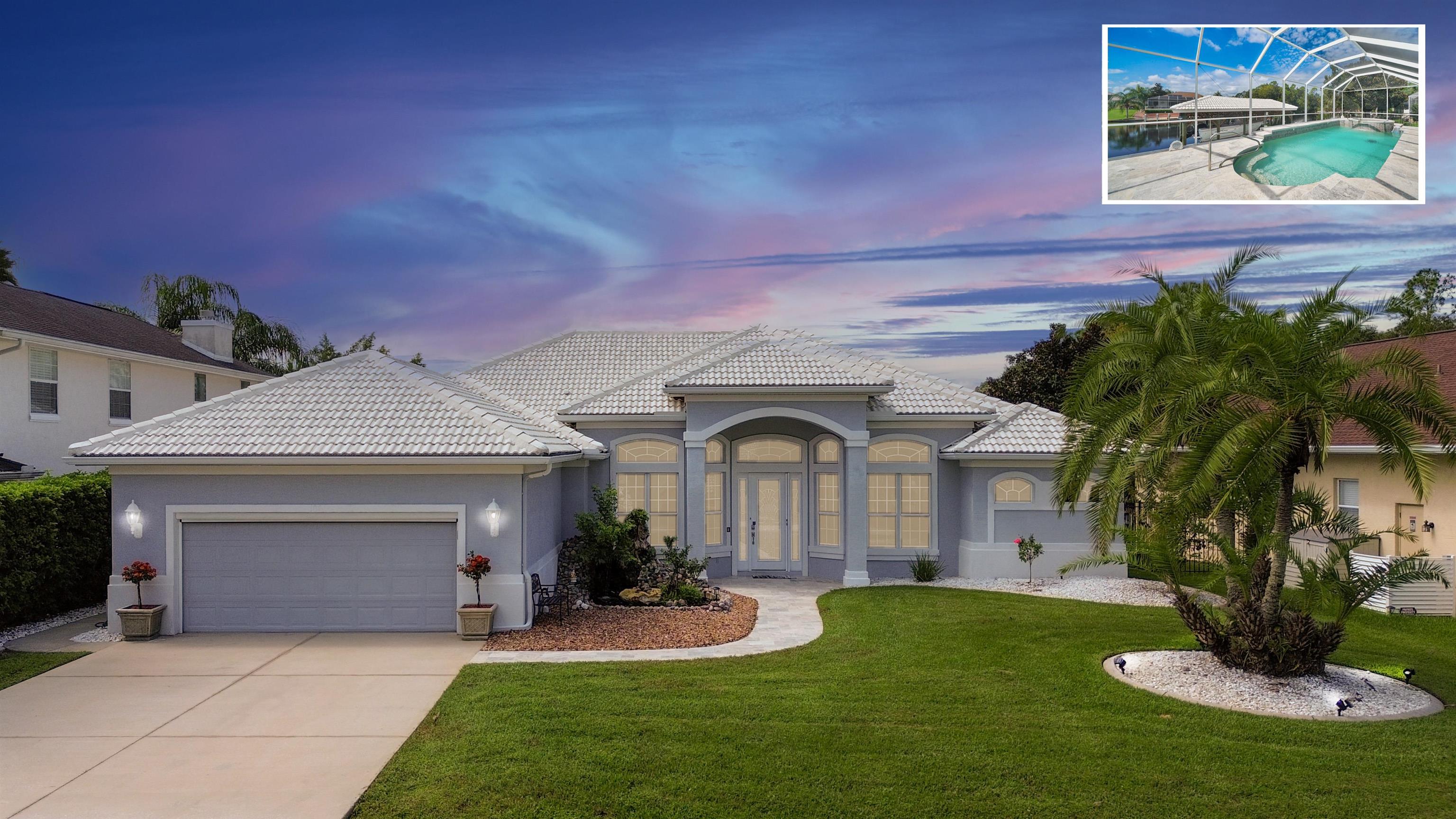 a front view of a house with a yard and garage