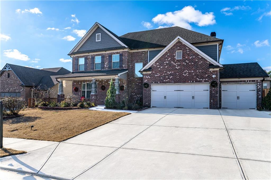 a front view of a house with a yard and garage