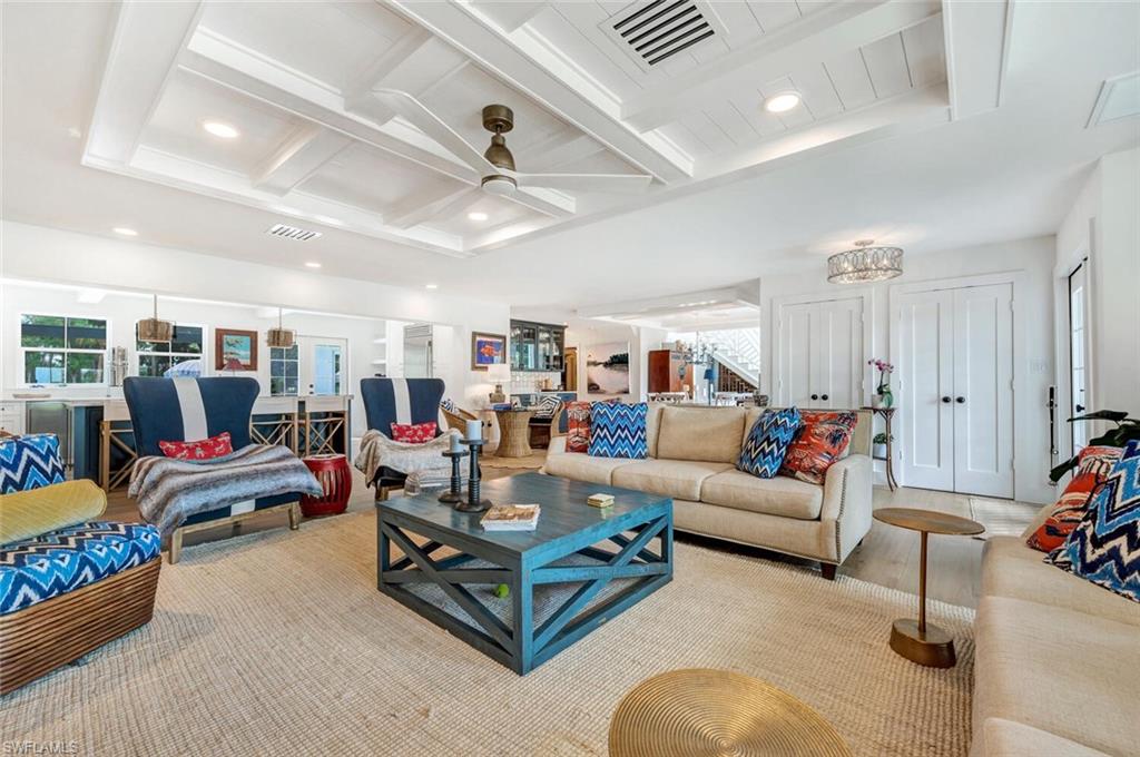 a living room with furniture and a ceiling fan