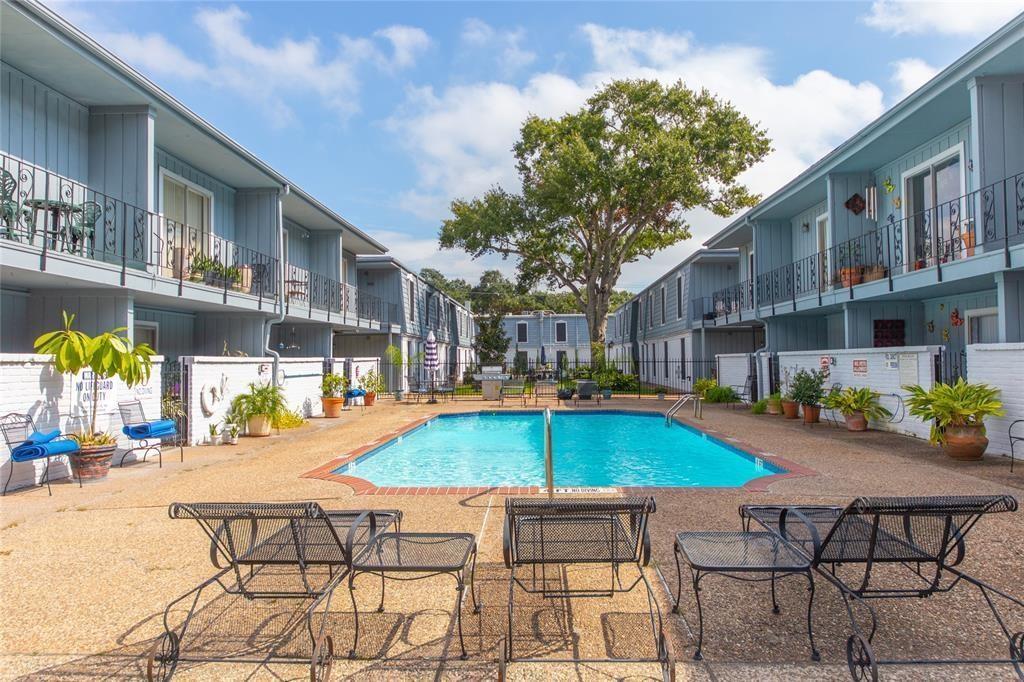 a swimming pool with outdoor seating and yard