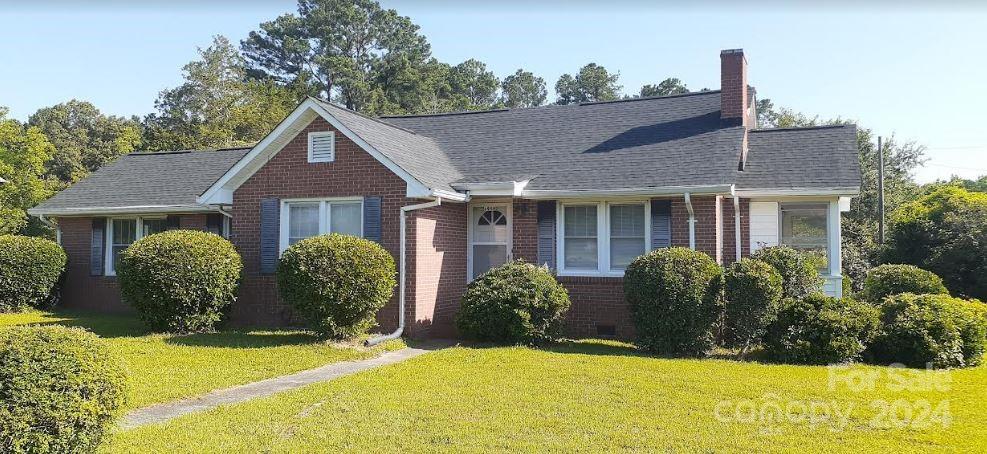 a view of house with yard and swimming pool