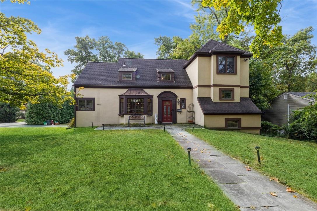 Tudor-style house with a front lawn