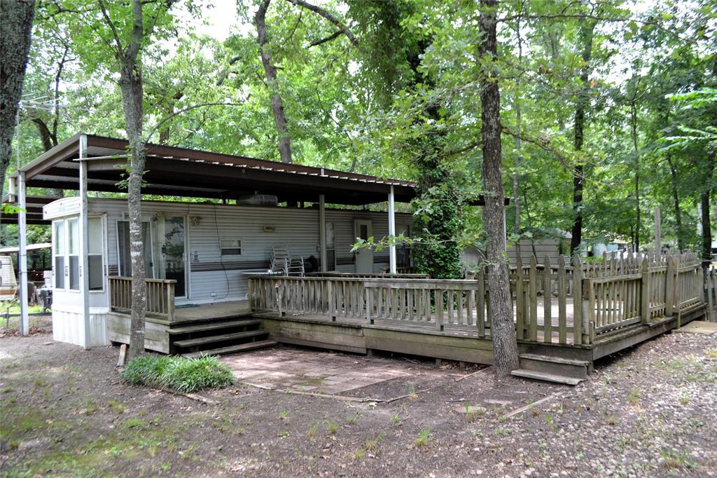 a view of house with a small yard and a large tree