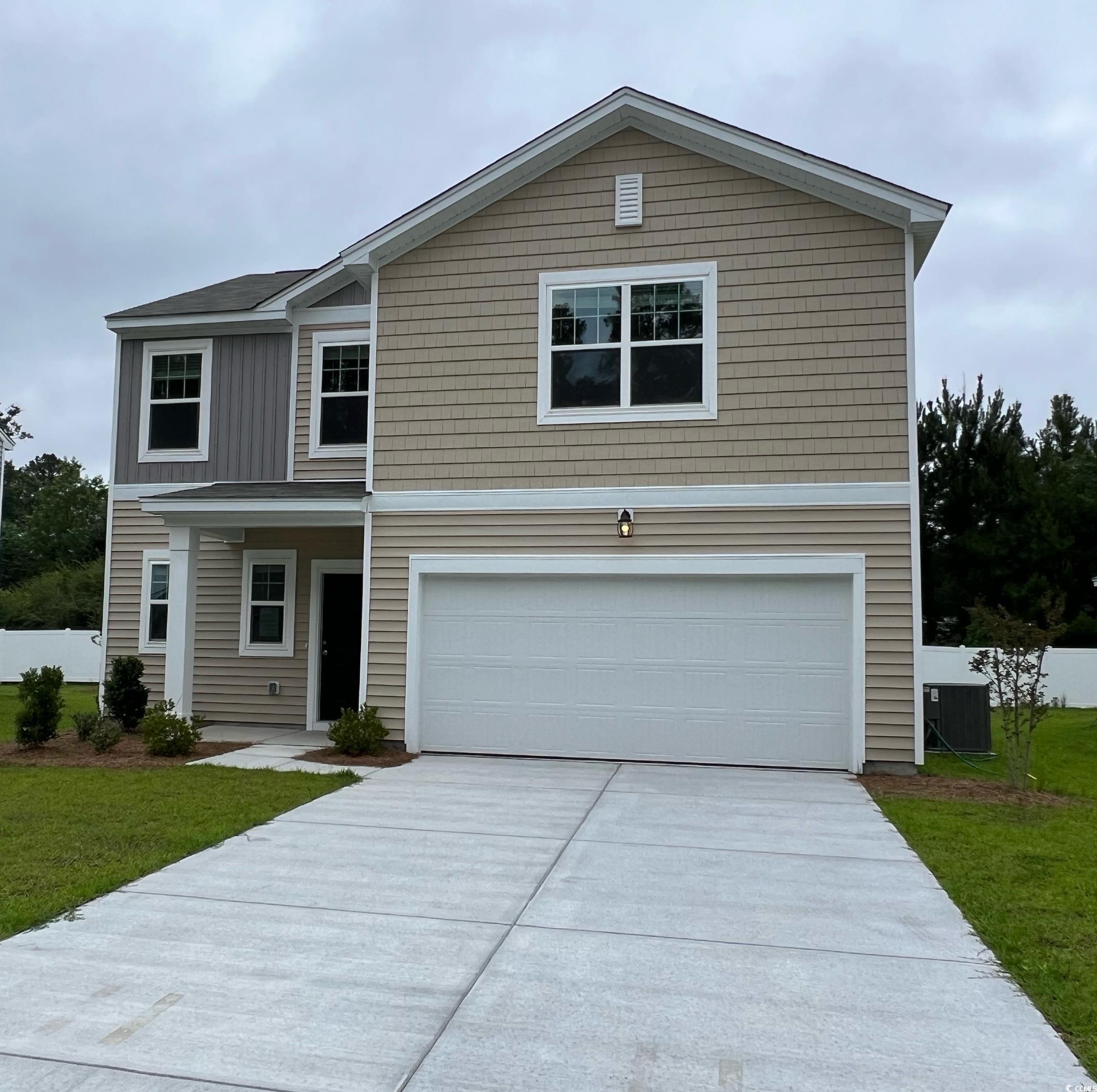 View of property with cooling unit, a front yard,