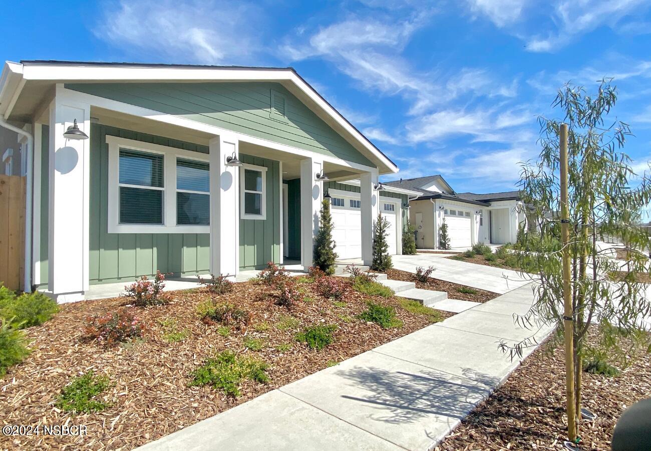 a view of a house with backyard porch and sitting area