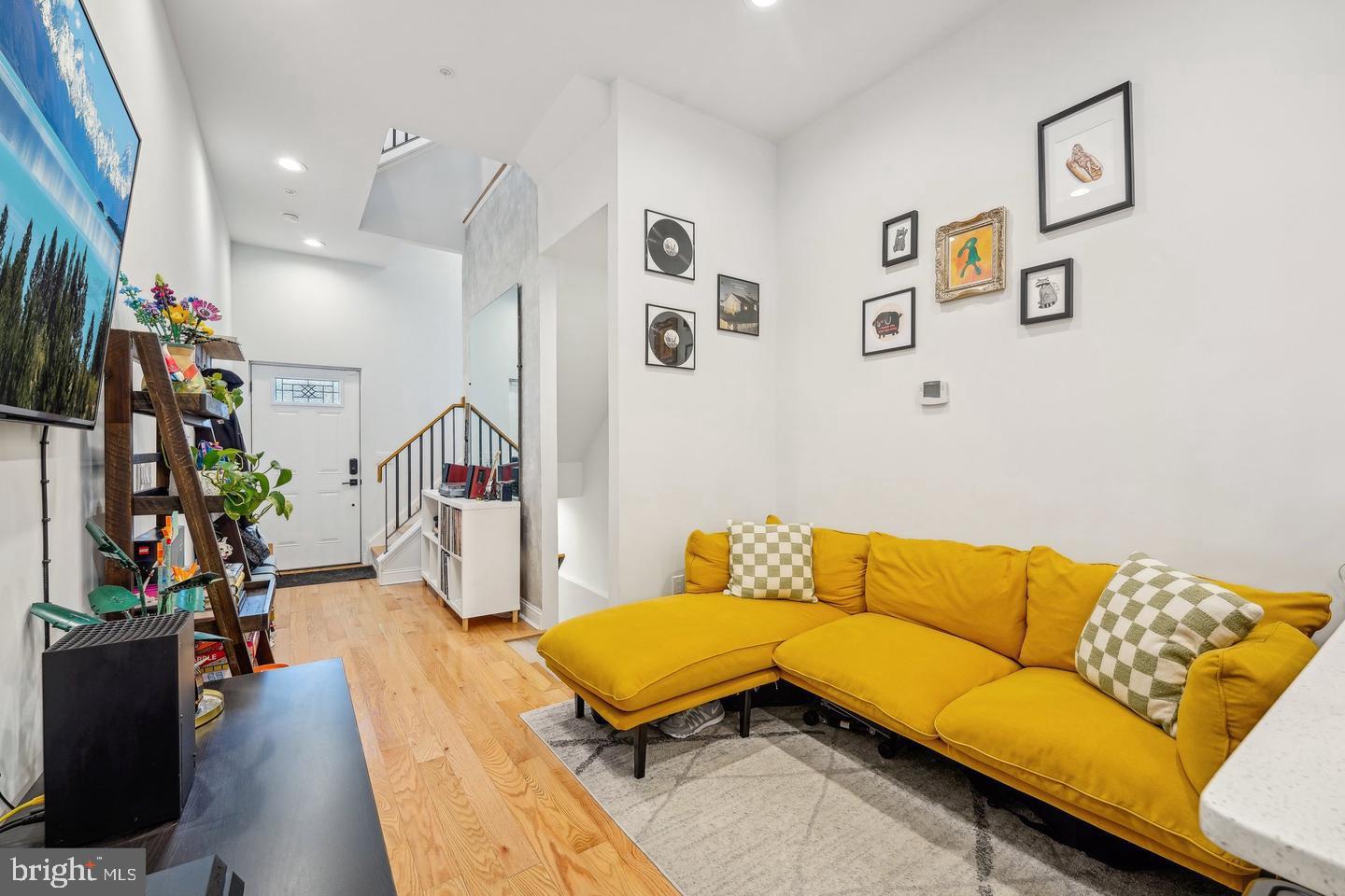 a living room with furniture and wooden floor