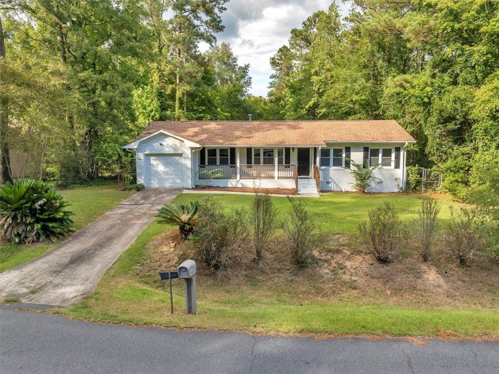 a view of a house with a yard patio and fire pit