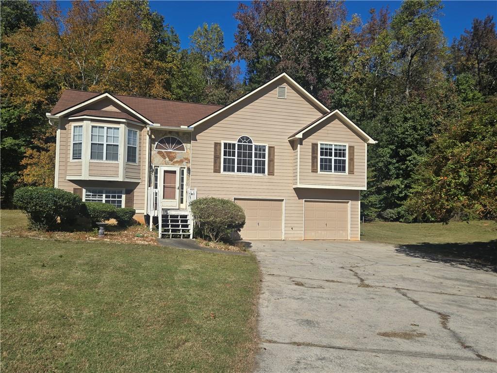 a front view of a house with a yard and garage