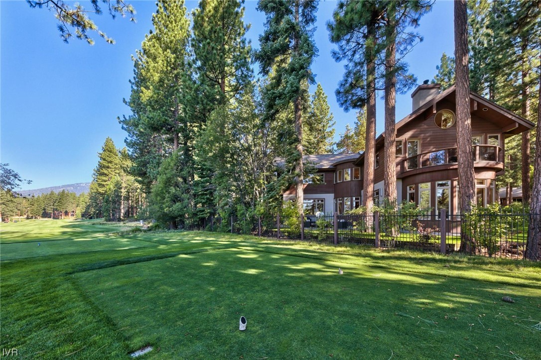 a view of a big building with a big yard and large trees