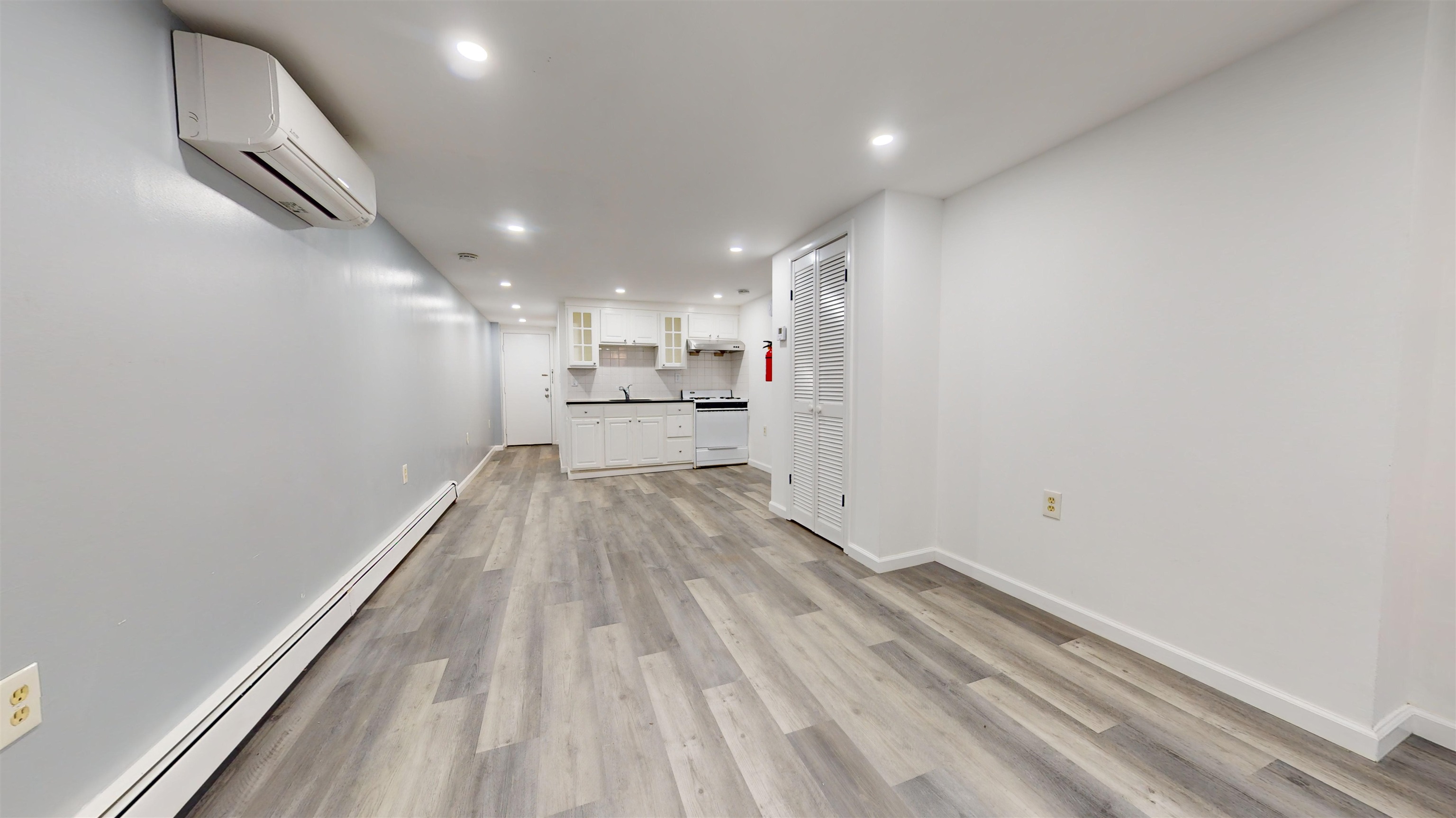 a view of a kitchen with wooden floor