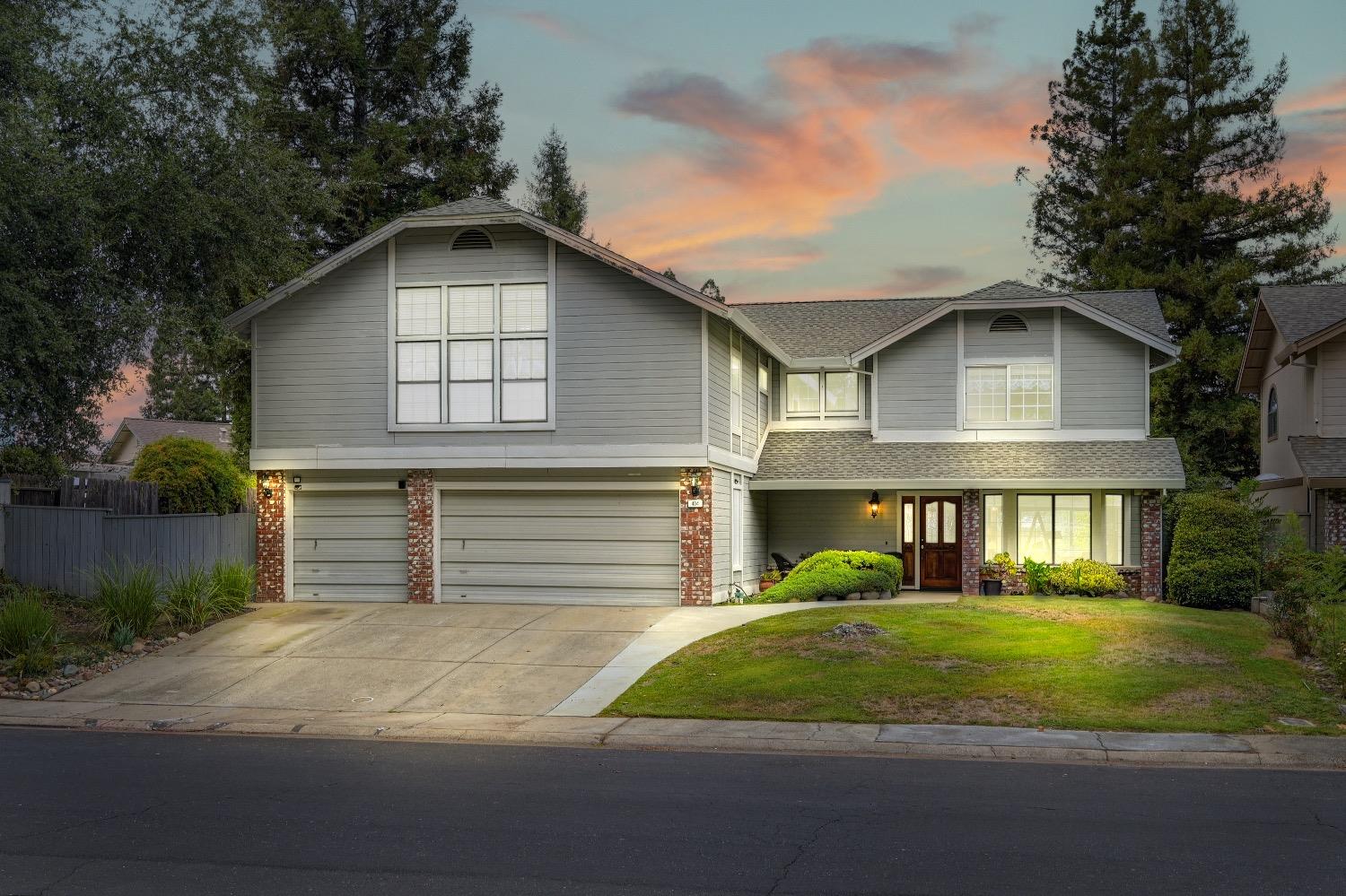 a front view of a house with a yard and garage