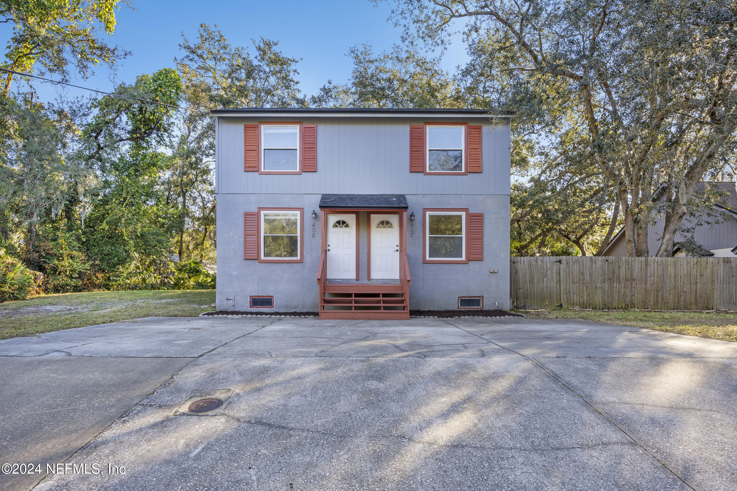 a house that has a tree in front of it