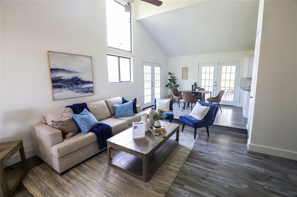 a living room with furniture wooden floor and a window