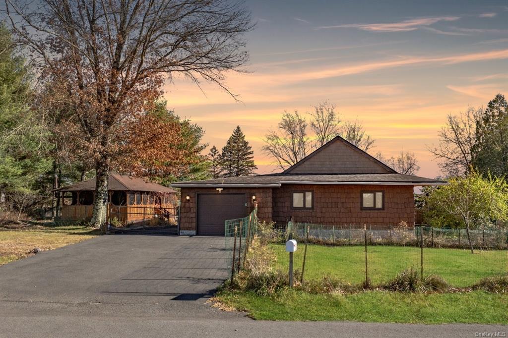 Ranch-style house with a lawn and a garage