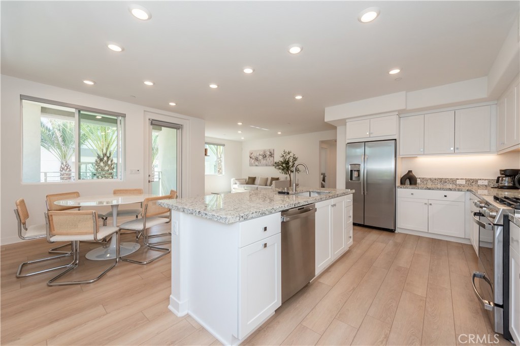 a kitchen with stainless steel appliances kitchen island granite countertop a sink and cabinets