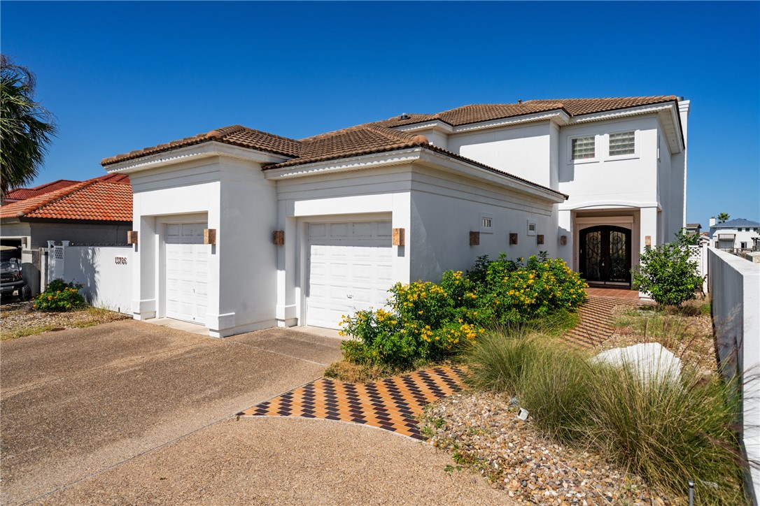 a front view of a house with garden