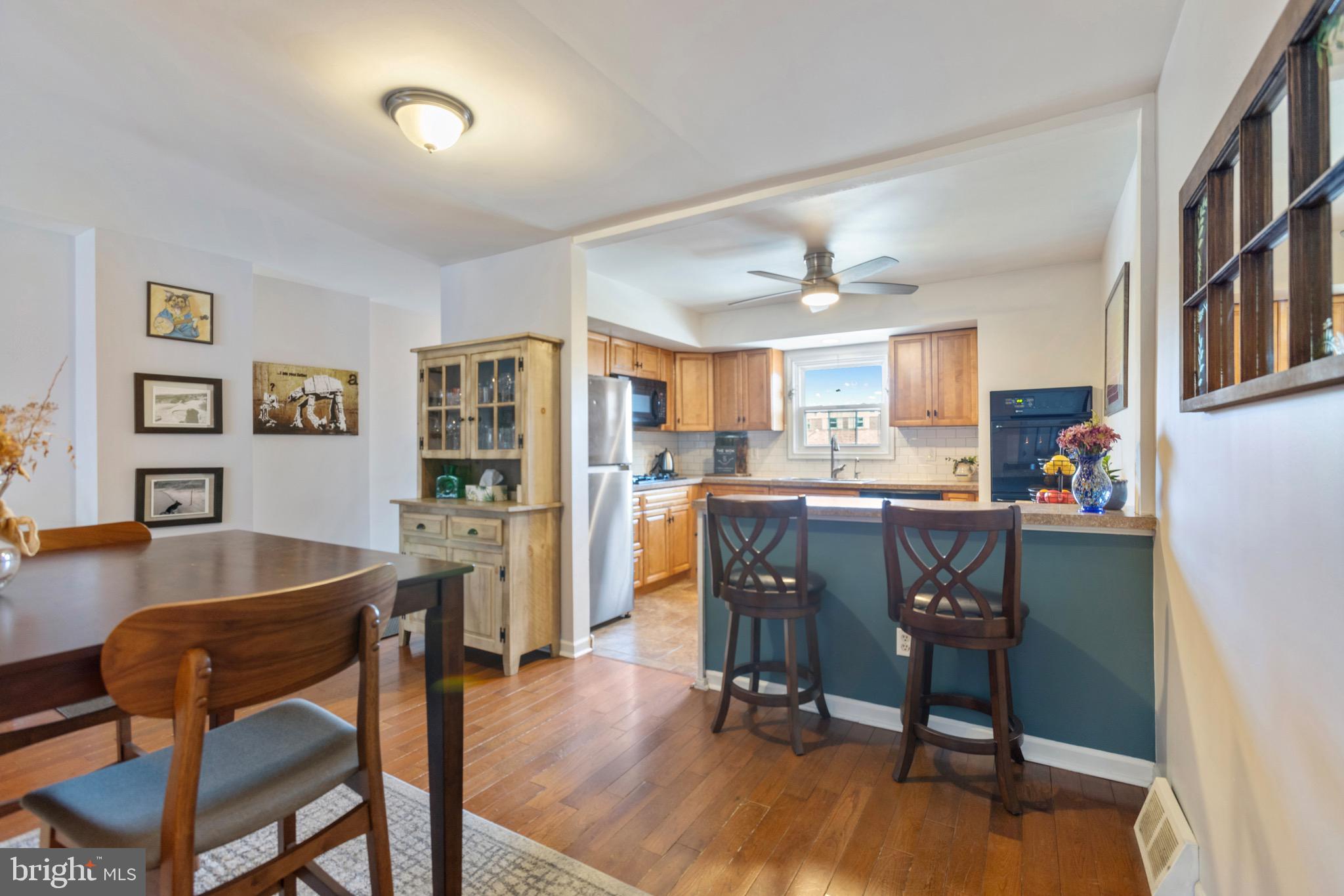 a view of a dining room with furniture and a kitchen