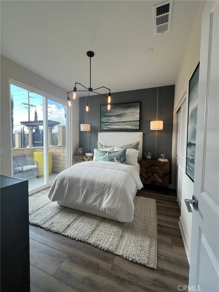 a bedroom with a large bed and a wooden floor