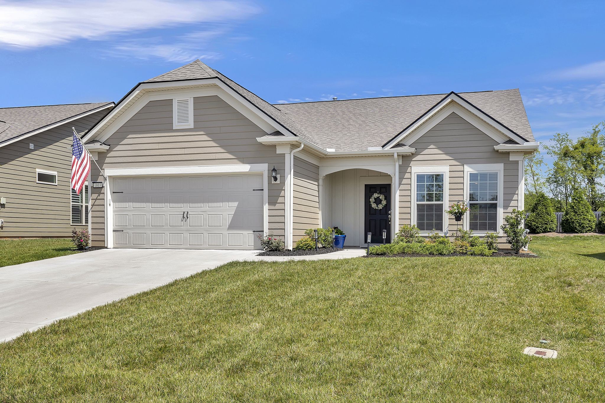 a front view of a house with a yard and garage