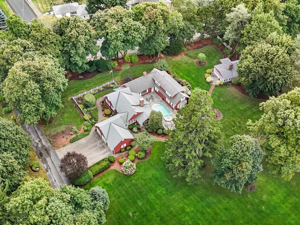 an aerial view of a house with garden space and street view