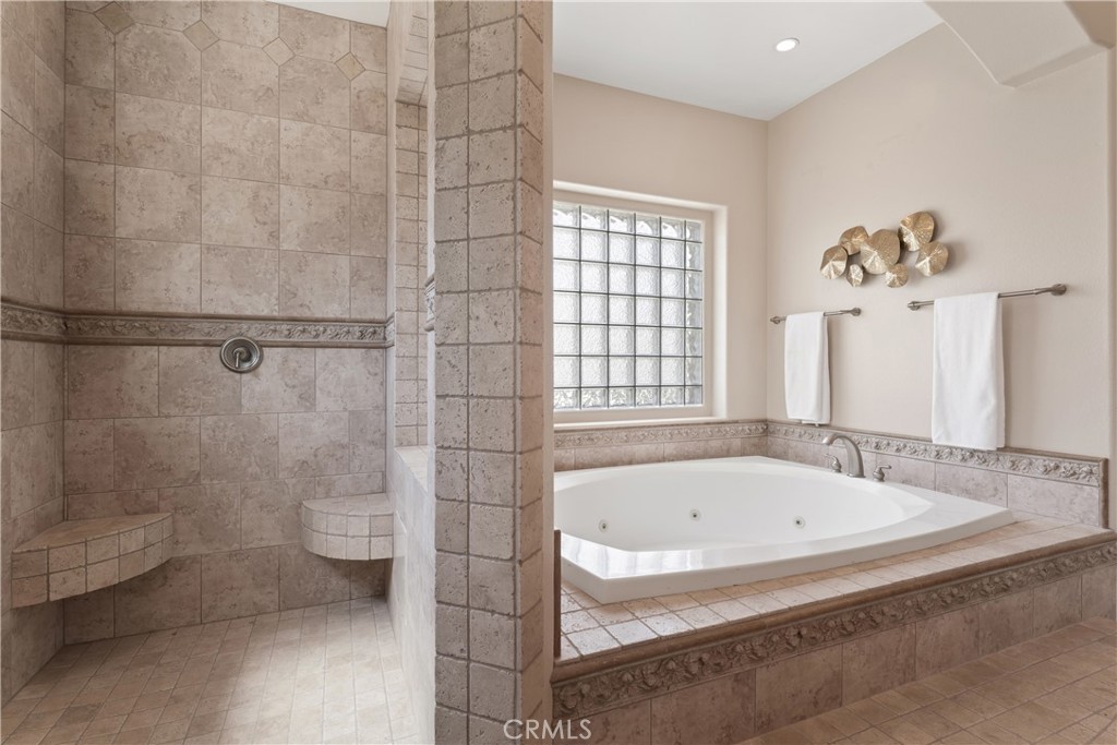 a bathroom with a bathtub and a shower