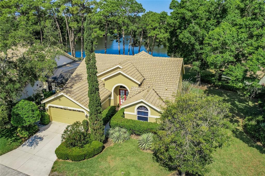 an aerial view of a house with a yard and plants