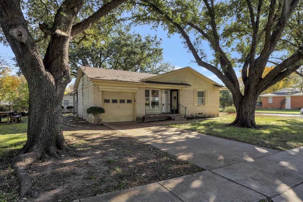 a view of a house with a tree in front of a house