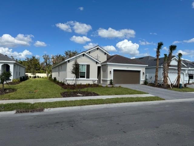 a front view of a house with a yard and garage