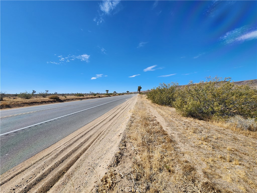 a view of a road with a building in the background