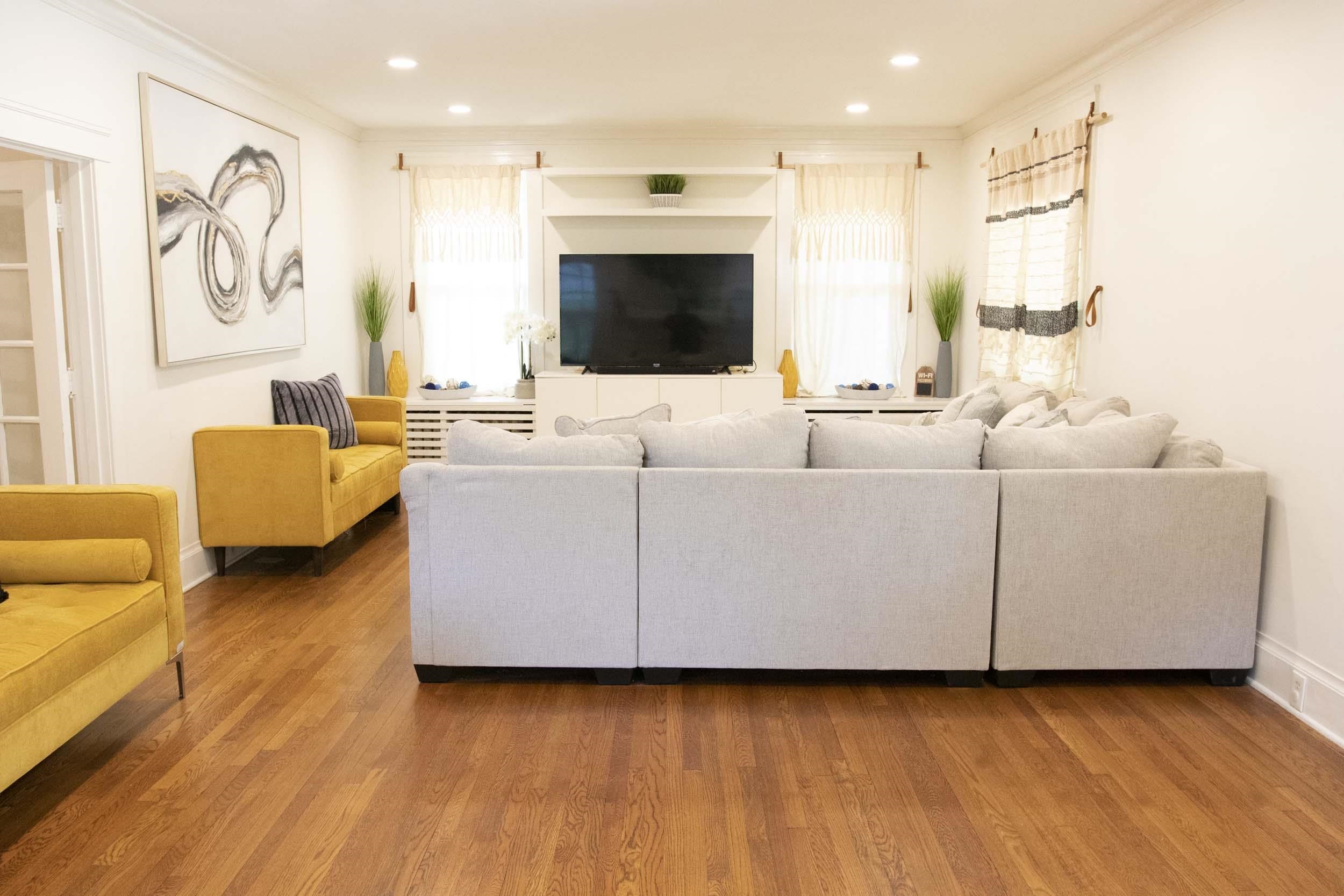 a living room with furniture and a flat screen tv