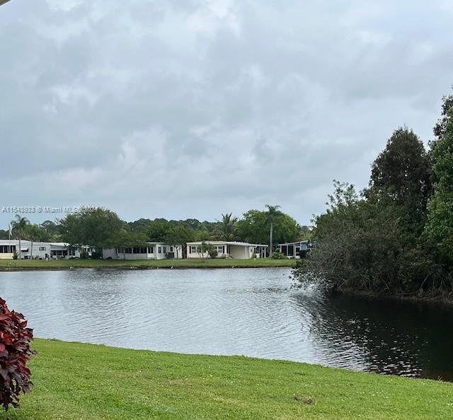 a view of a lake with houses in the back