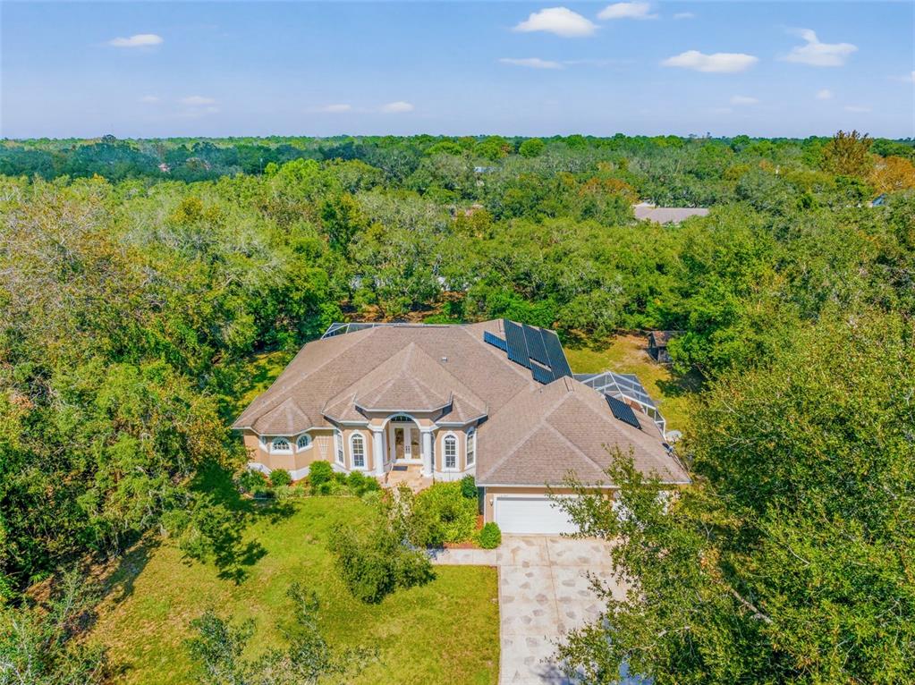 an aerial view of a house with garden space and outdoor space