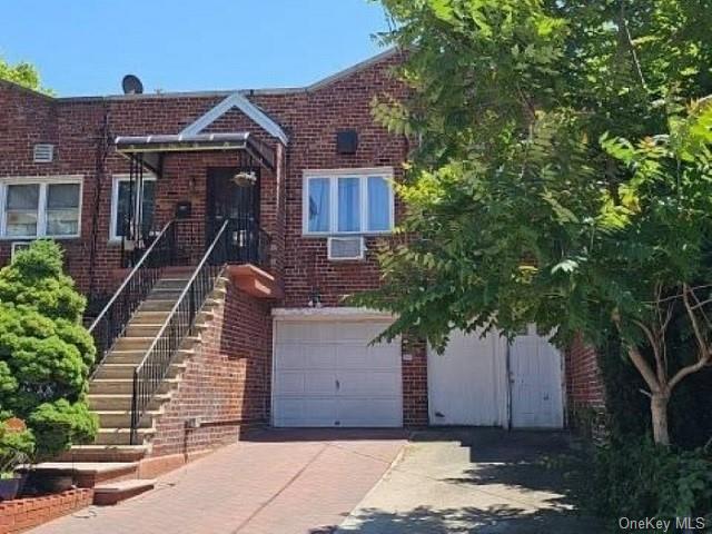 a front view of a house with a tree