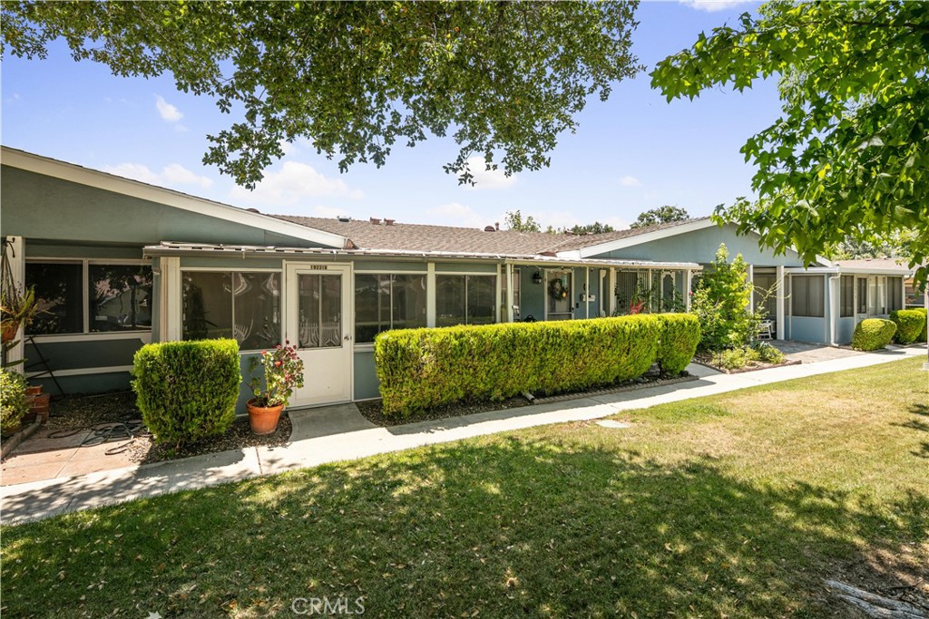 a front view of a house with a garden and porch