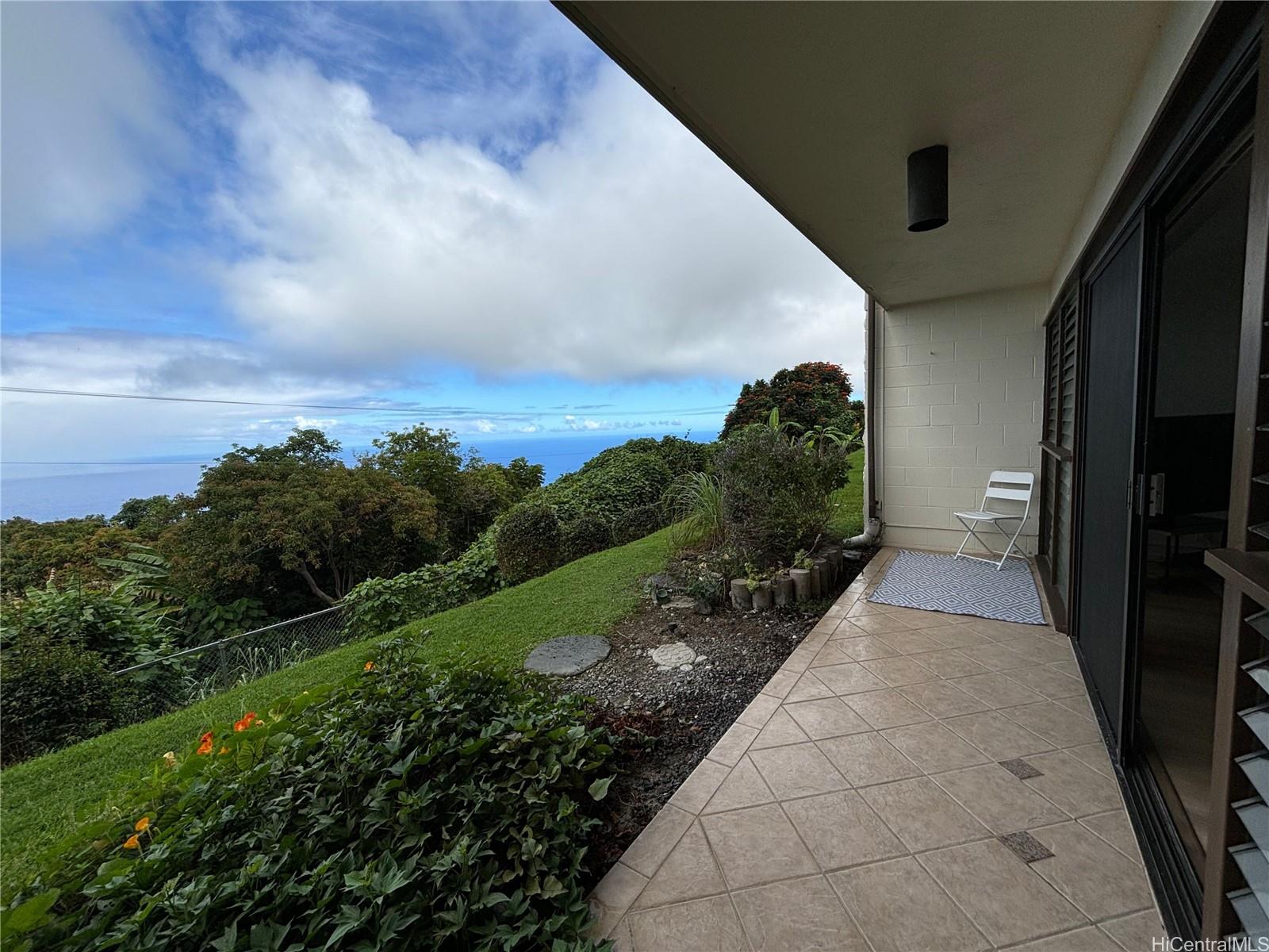 Front covered lanai with herb garden and sweet potato.