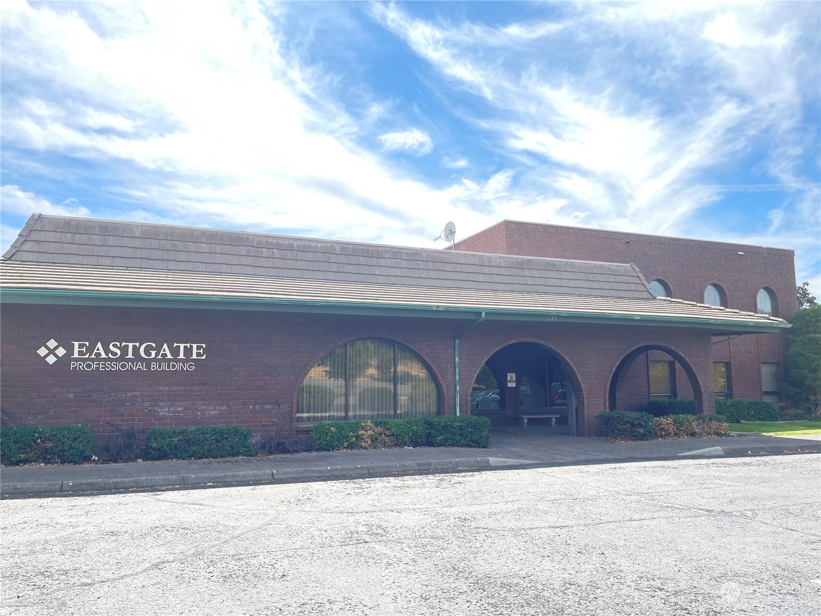 a front view of building with parking