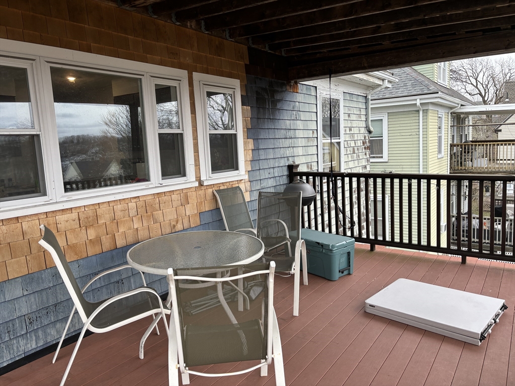 a balcony with table and chairs