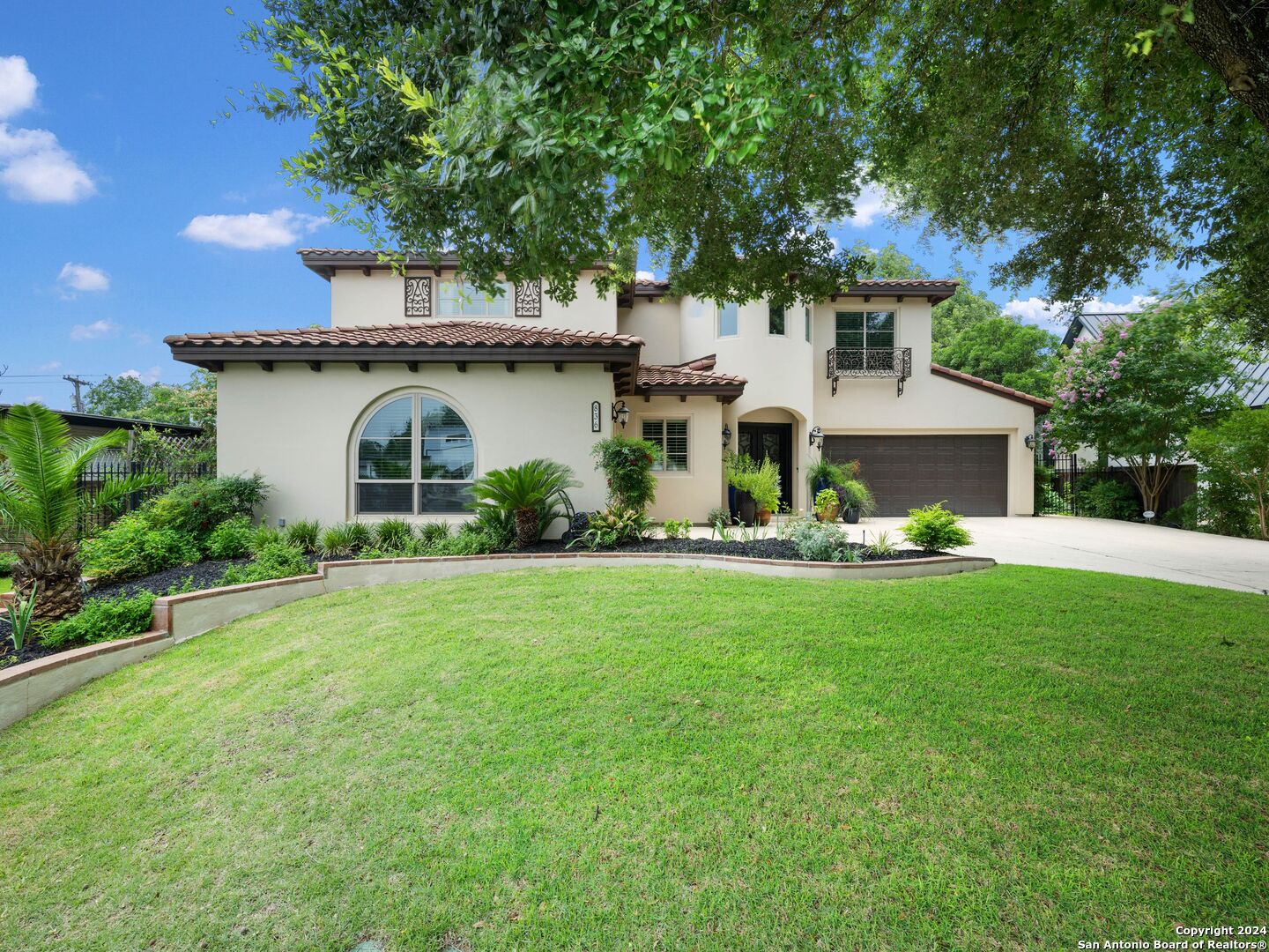 a front view of a house with garden