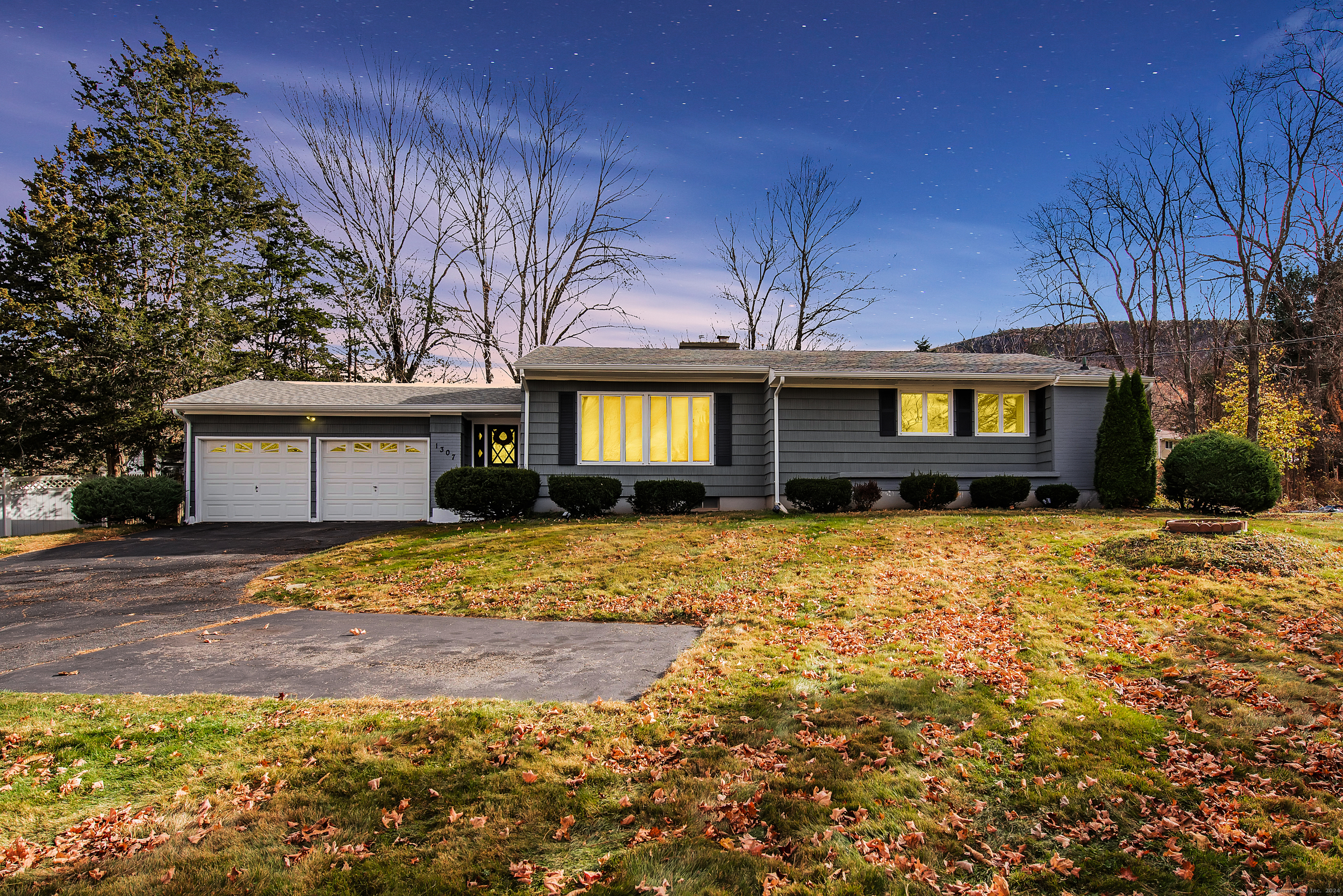 a front view of a house with a garden and yard