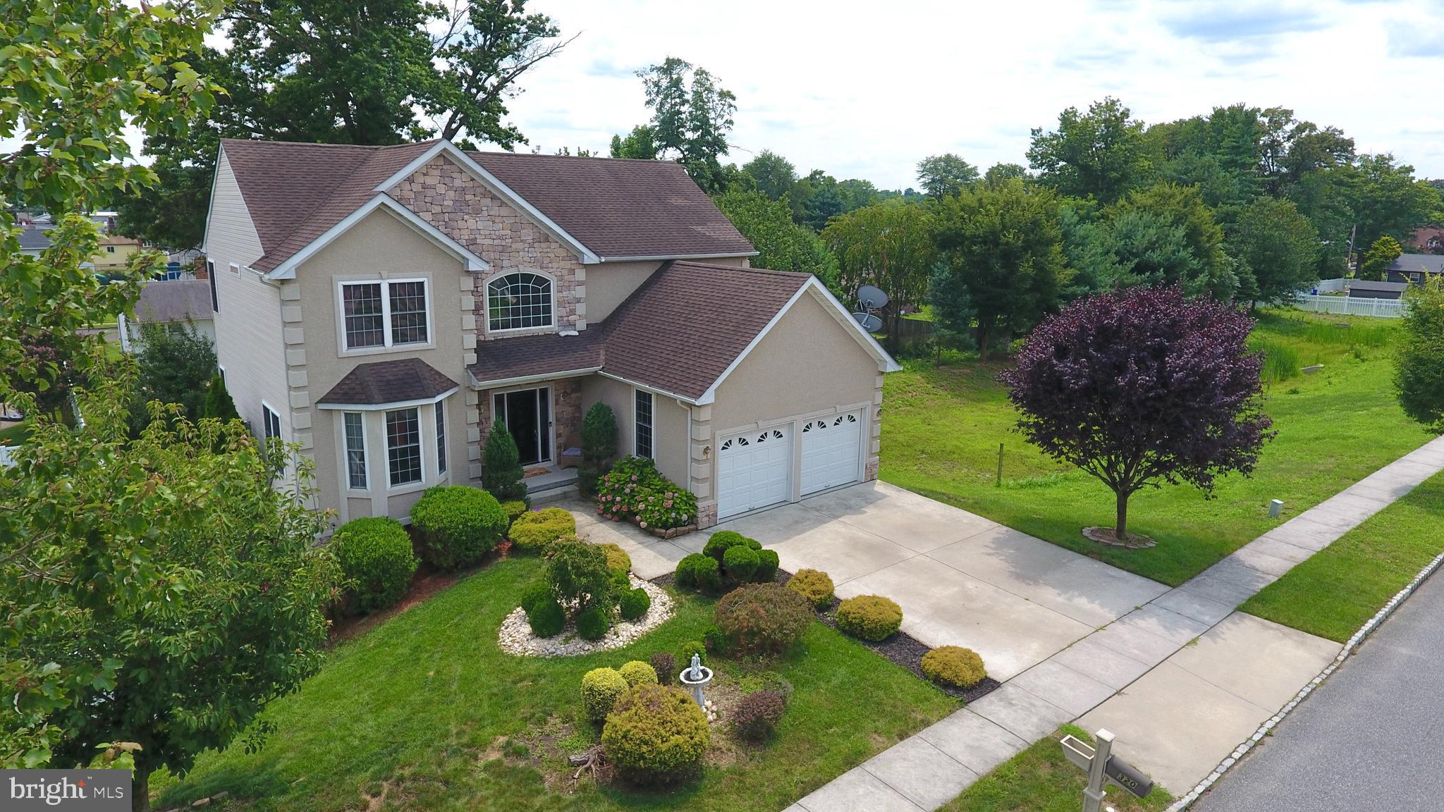 a aerial view of a house with a yard and potted plants