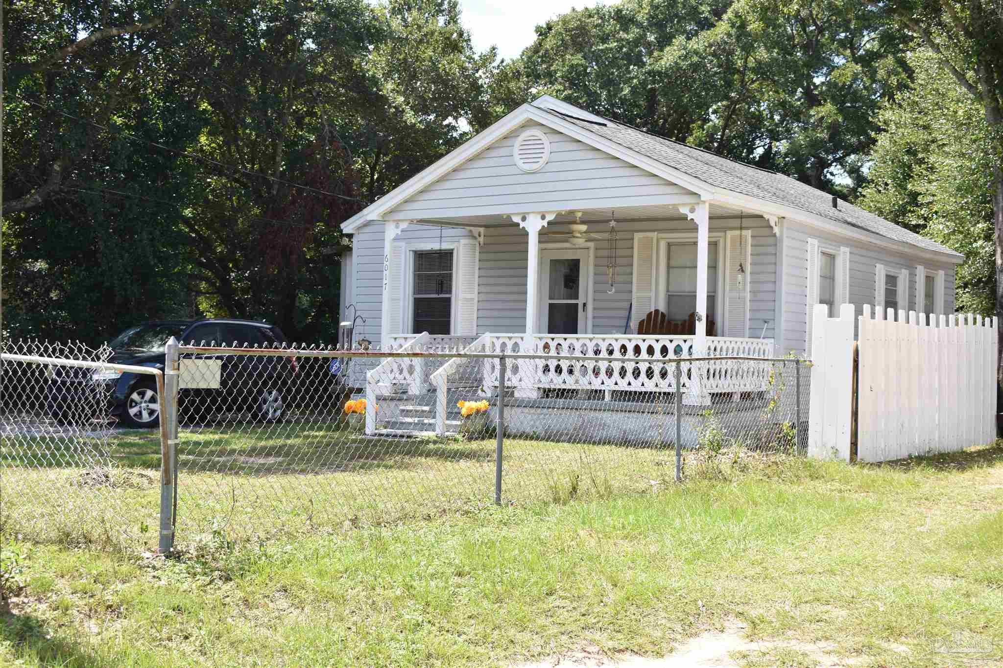 a front view of a house with a yard table and chairs